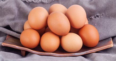 many eggs are placed on a ceramic tray.