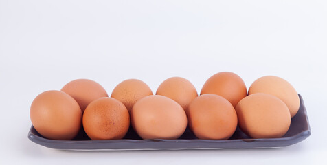chicken eggs lies in a japaness ceramic saucer on white background.