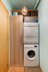 Narrow utility room with washing machine and dryer.