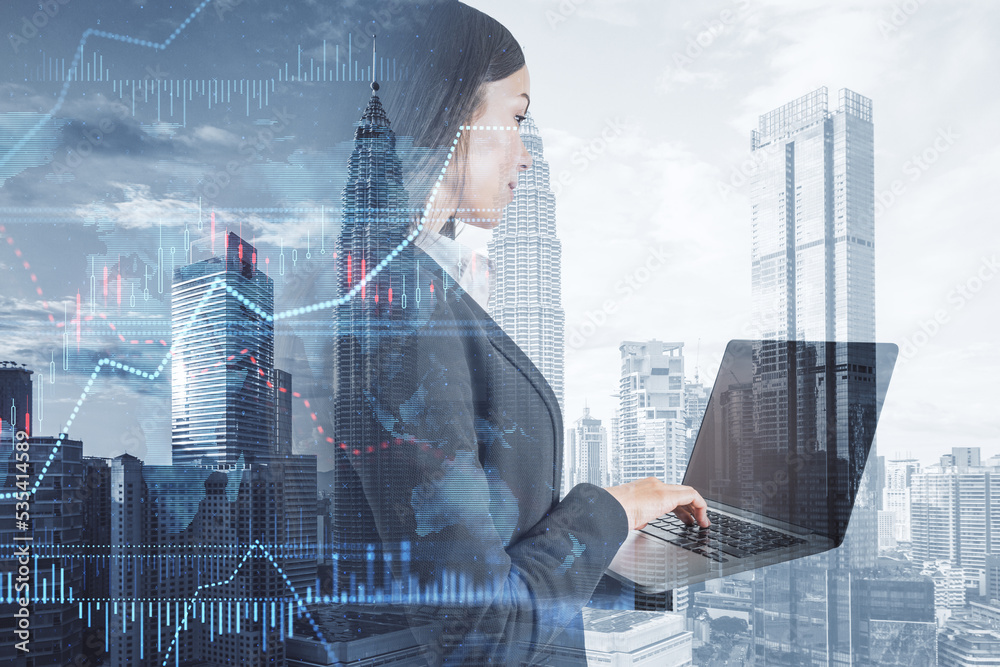 Poster businesswoman using laptop with creative forex chart with candlestick graph, index and tech hologram