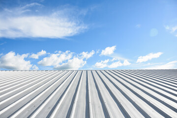 metal sheet roofing on commercial construction with blue sky - obrazy, fototapety, plakaty