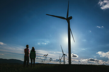 Fototapeta na wymiar Silhouette of engineers at wind turbine electricity industrial