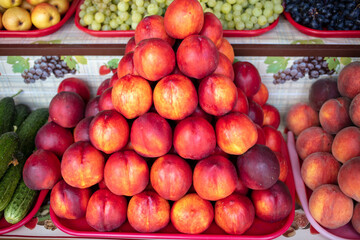 Naklejka na ściany i meble Peaches on the counter in the market.