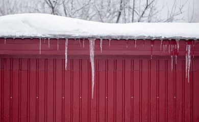 Icicles hang from the roof of the house.