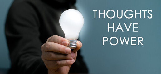 Hand holding light bulb with text Thoughts Have Power, The power of thinking ideas, think big. - 535421998