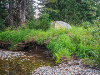 Camping in backpacking tent next to river