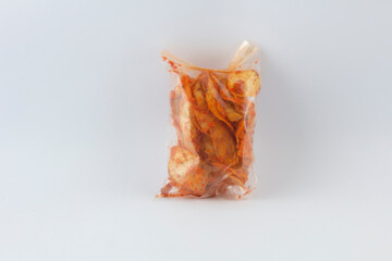 indonesian spicy food made from cassava, cassava chips packed in plastic, isolated at white background