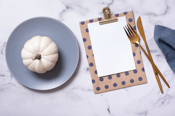 Autumn flat lay with blank tablet and decorative pumpkins on marble background top view