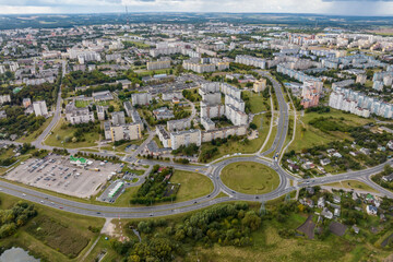 aerial panoramic view from a great height of a small provincial green town with a private sector and high-rise apartment buildings