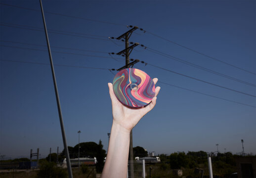 Hand Holding a CD Mockup With Flash Light