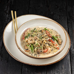 delicious pasta with cheese, meat, herbs, sauce in a restaurant
