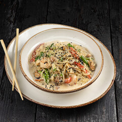 delicious pasta with cheese, meat, herbs, sauce in a restaurant
