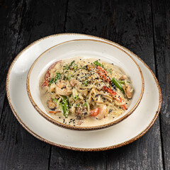 delicious pasta with cheese, meat, herbs, sauce in a restaurant
