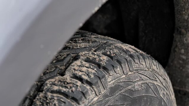 off-road tire with a deep tread
close up of winter tires on a car
new wheels on the car
camera movement