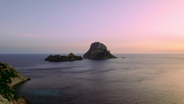 Aerial view of Es Vedra Ibiza during sunset. Showing ocean and clear skies. Cinematic 4K
