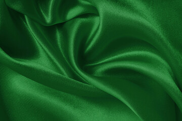 Dark green fabric cloth texture for background and design art work, beautiful crumpled pattern of silk or linen.