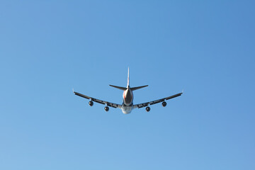Fototapeta na wymiar 747 tail view wheels up in a blue sky - stock photo.jpg