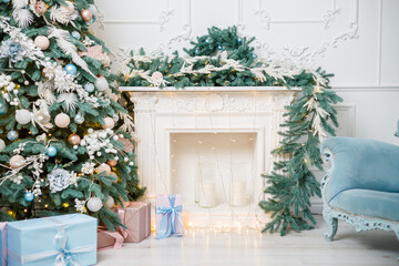 A beautifully decorated bright room for the New Year. Christmas tree, gifts under the tree. the fireplace is decorated with garlands