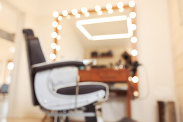 Blurred view of professional barber chair in hairdressing salon