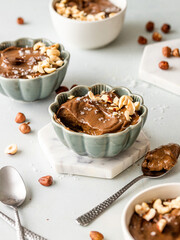 Vegan no bake and no sugar raw chocolate pudding with dates and crushed hazelnuts 