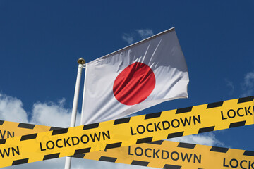 Japan flag against the sky and a protective tape with the inscription lockdown. Concept - Japan is...