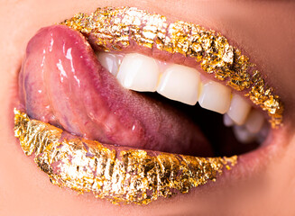 lips and makeup. Golden lips. Sexy woman face. Teeth. Photo. Background. 