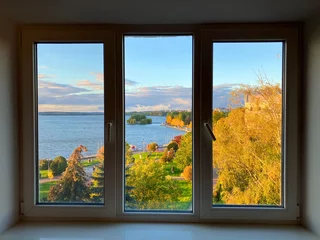 Fotobehang Per ruimte Nice view from the window. Three-leaf window, autumn. Outside the window there is a lake and an autumn park, yellow leaves on the trees. Triptych  © ShU studio