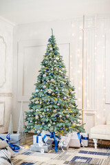 The guest room is decorated for Christmas, a tree with gifts and toys, Christmas balls