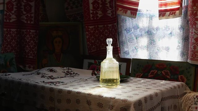 an authentic Ukrainian house
there is a bottle of moonshine on the table covered with an embroidered towel
Ukrainian national symbols