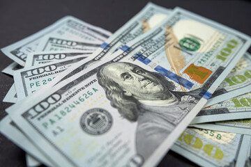 large amount of US dollars isolated on a black background.