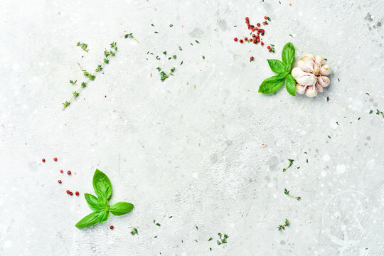Basil. Spices and herbs on a stone background. Cooking concept. Top view. Free space for your text.