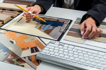 Designer woman plans home interior illustrates chooses perfect colors for new home with samples