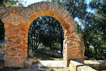 Fototapeta na wymiar An arch among the ruins of Cuma, an ancient city near Naples, Italy.