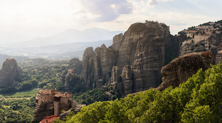 Fototapeta na wymiar From some viewpoint, tourists have a rare chance to see in one direction up to 4 monasteries on clifftops, Strong visual impact, popularization of Christianity. Meteora, Greece
