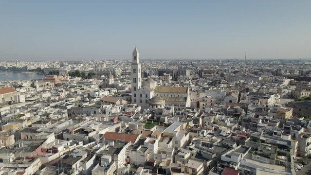 Aerial view of the maritime city Bari and the Bari cathedral tower, approaching the church tower