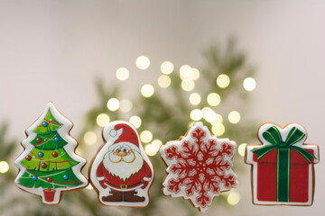 Close-up of gingerbread Christmas cakes: tree, Santa Claus. snowflake, a gift against a blur background. Christmas background for Christmas card. Set of different Christmas cookies 