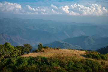 blue sky landscape with clouds. top of mountain before sunset time.  layers of hill background. scenery view wallpaper. mixed forest and prairie area.
