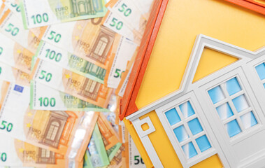 House model on the background of banknotes. Buying and renting real estate. Credits.