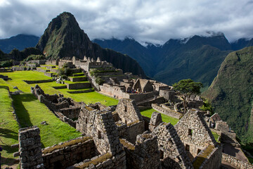 The ancient ruins of buildings at Machu Picchu which is a 15th-century Inca site located 2,430m...