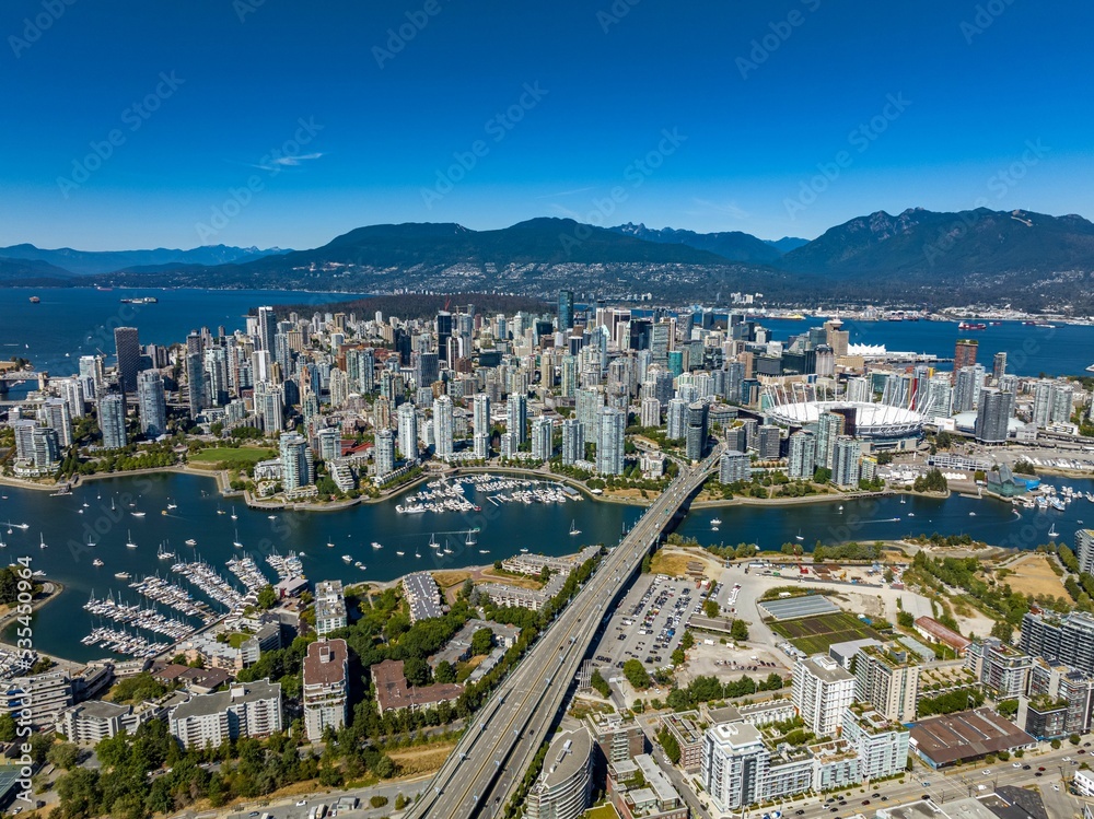 Wall mural aerial drone view of downtown of vancouver with modern buildings under a blue sky