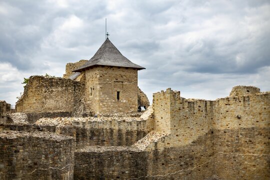 View of the ruins of Cetatea de Scaun a Sucevei under the cloudy sky in Suceava