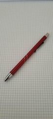 Red pen on a college block