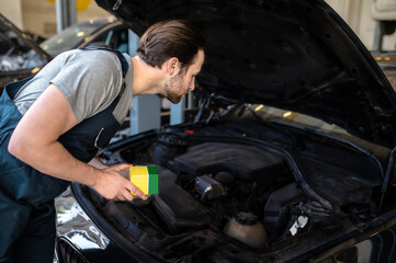 Car repair worker working at the service station