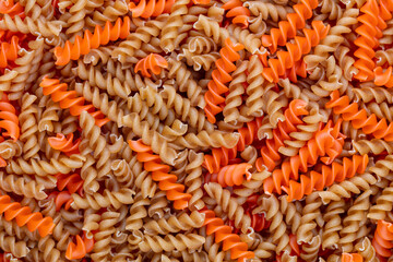 Whole, lentils fusilli pasta background.