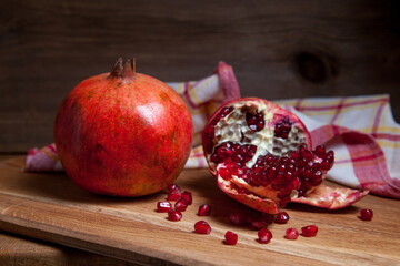 Fresh red pomegranate on a wooden background..