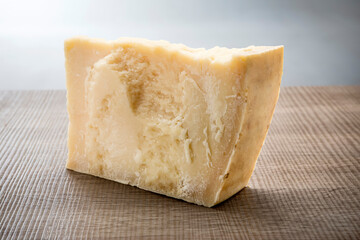 piece of parmesan cheese on wooden table