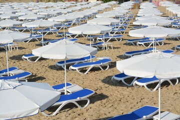 Many beach umbrellas and sunbeds on resort