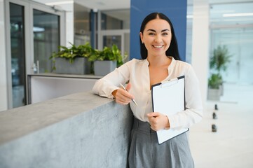 Portrait of beautiful receptionist near counter in hotel