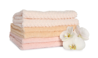 Obraz na płótnie Canvas Stack of clean soft towels with orchids isolated on white