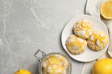 Flat lay composition with tasty lemon cookies on grey table. Space for text